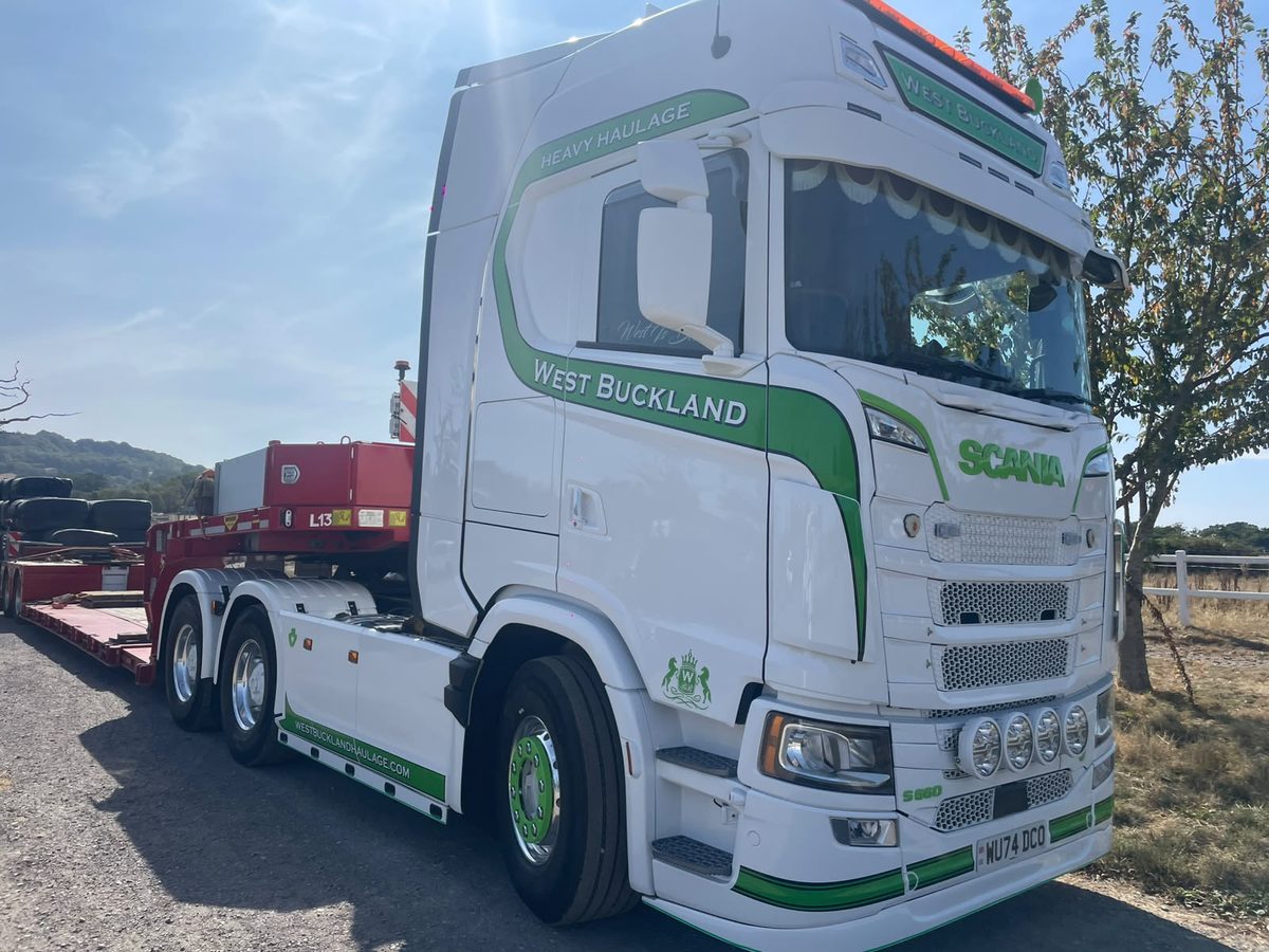 West Buckland Scania tractor unit coupled to a low loader carrying plant machinery